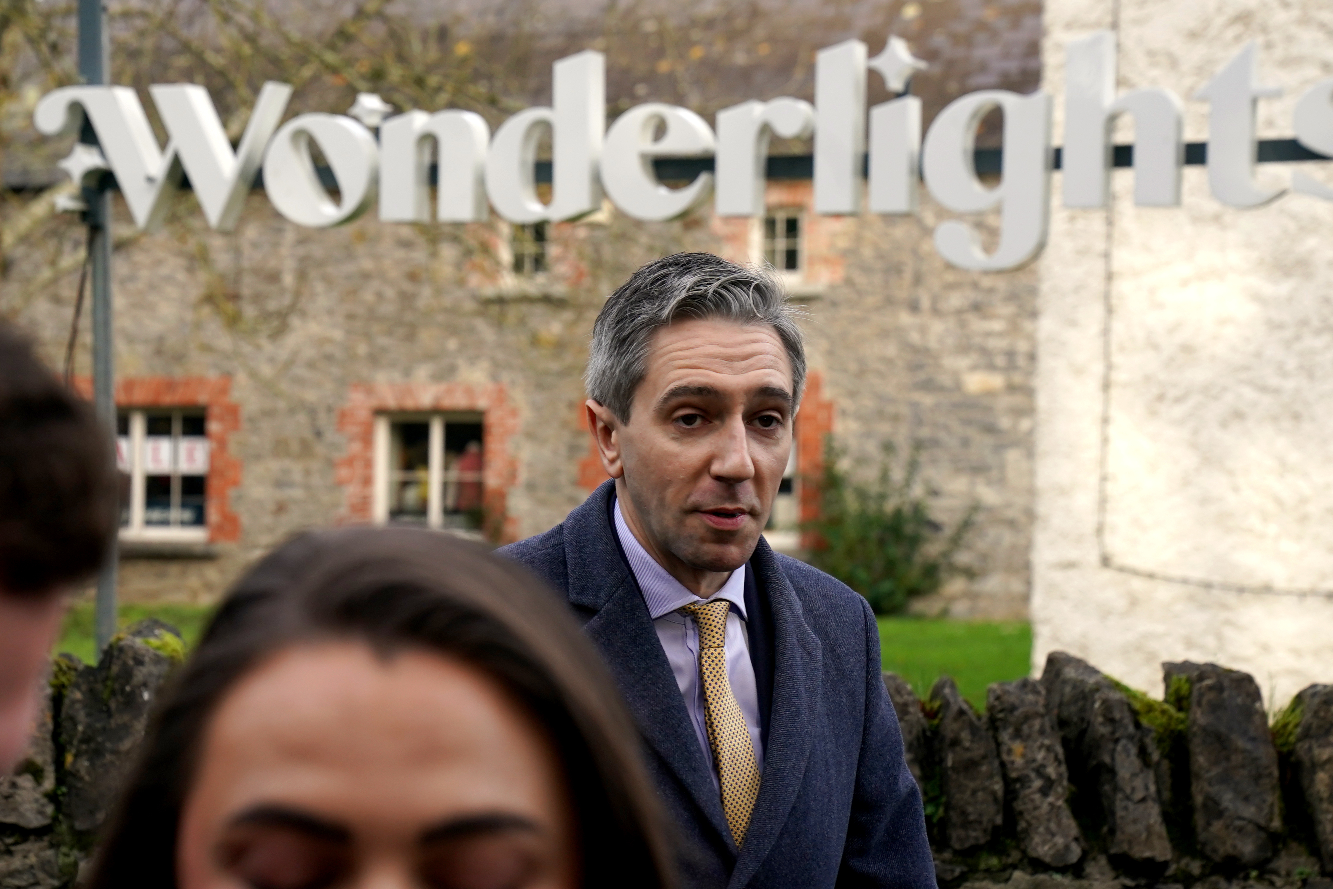 Taoiseach Simon Harris underneath a sign saying Wonderlight