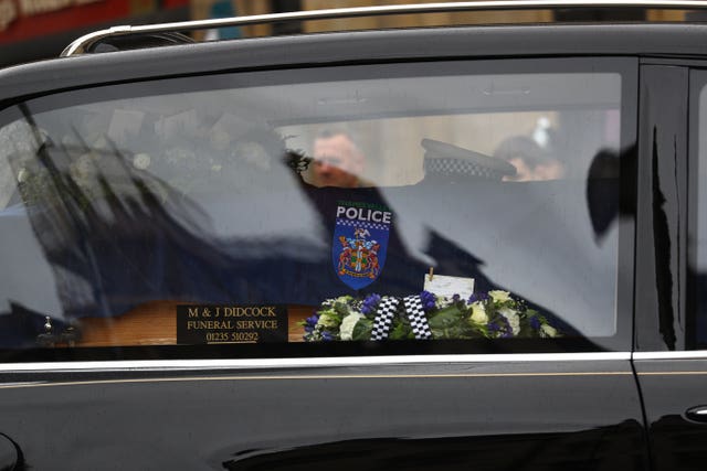 The funeral cortege passes through the streets of Oxford