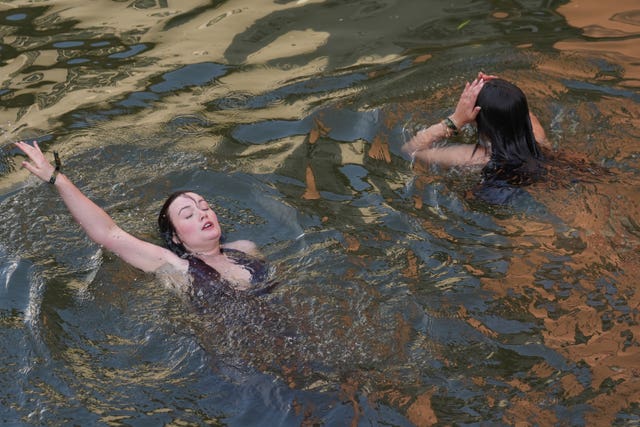Two female students swimming in the River Cam