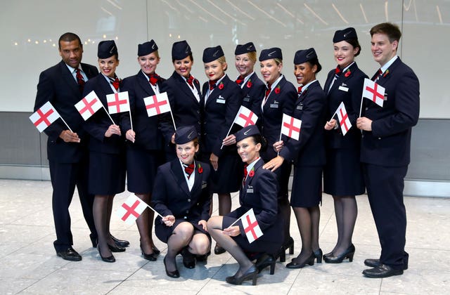 British Airways staff wait with England flags