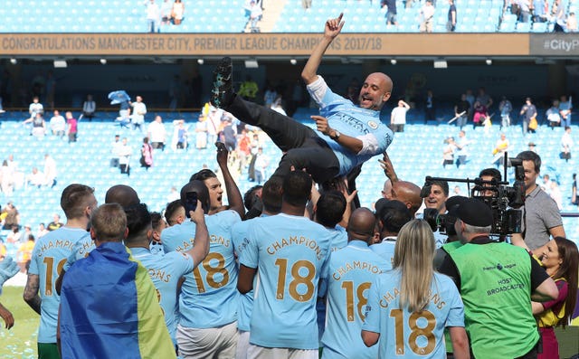 Pep Guardiola is thrown in the air by his players as Manchester City celebrate the 2017-18 title
