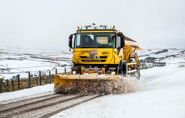 A gritter lorry at work in snowy conditions (Danny Lawson/PA)