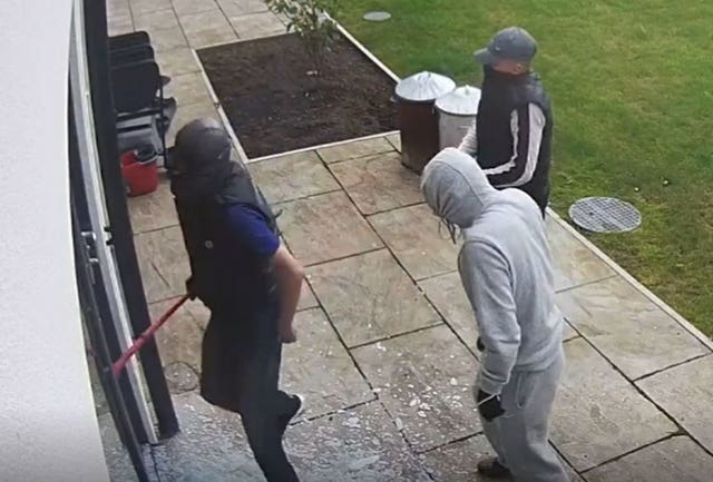Screen grab from handout footage of Daniel Flynn (sleeveless, left) during a burglary of the home of Cardiff City footballer Sol Bamba