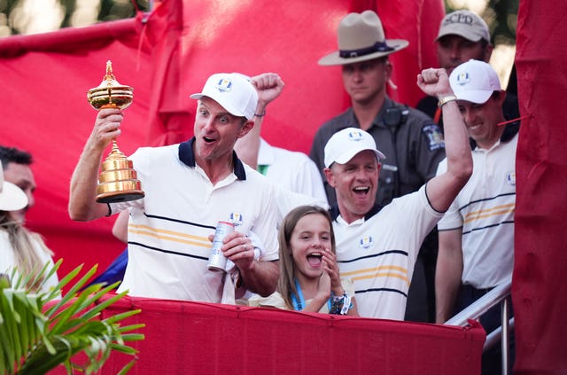 Justin Rose, left, celebrates with the Ryder Cup trophy