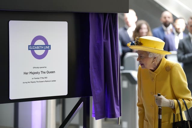 The Queen unveils a plaque to mark the Elizabeth line’s official opening at Paddington station in London