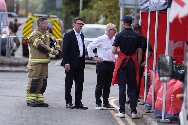 Prime Minister Andy Burnham, second left, speaking to workers from the Rapid Relief Team during a visit to Stourbridge in the West Midlands
