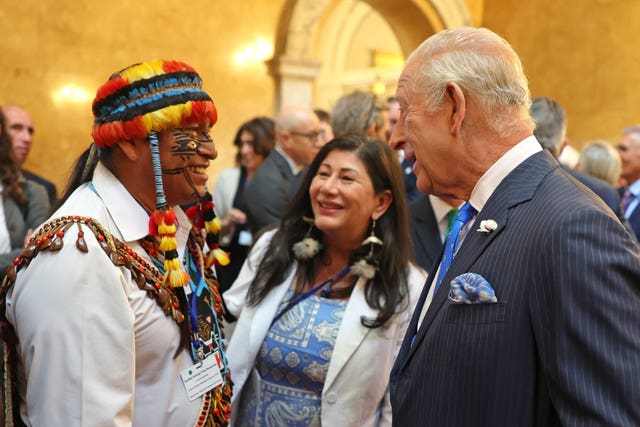Charles speaks with the founding member of the Amazon Sacred Headwaters Alliance, Uyunkar Domingo Peas Nampichkai, during a reception at Lancaster House
