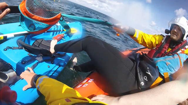 An RNLI crew rescues a kayaker