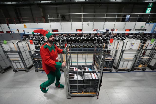 Mark Dawson pushes a mail trolley while dressed as an elf