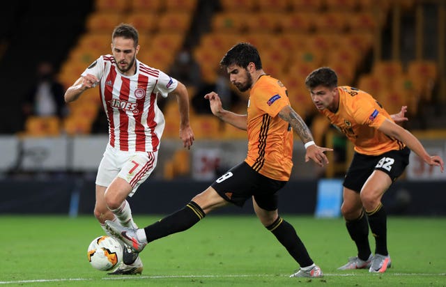 Ruben Neves and Olympiacos’ Kostas Fortounis battle for the ball