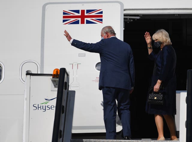 The Prince of Wales and the Duchess of Cornwall wave as they board a flight at Athens International Airport, Greece (Victoria Jones/PA)
