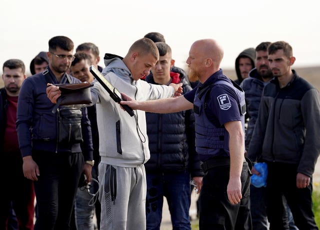 Security checks on people on a beach