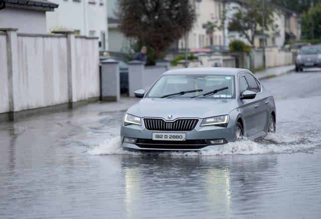 A car being drive through floorwater