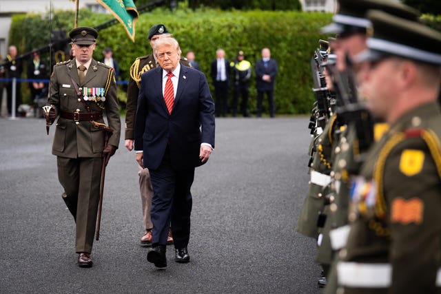 US President Donald Trump views the guard of honour outside Áras an Uachtaráin