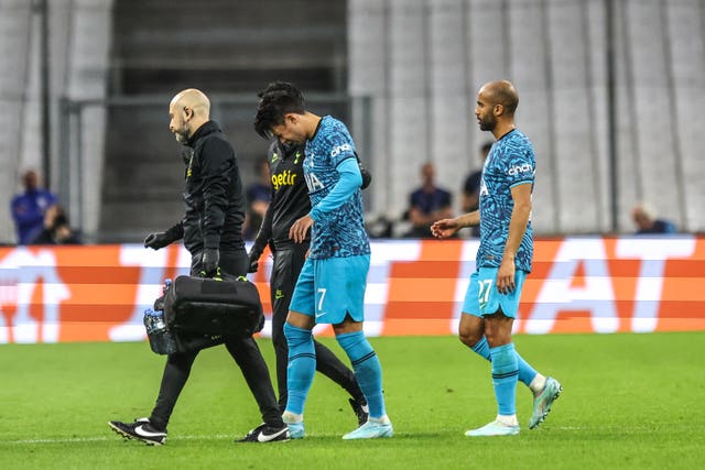Son Heung-min, centre, leaves the field injured