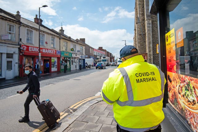 A Covid marshal on patrol in Bedford (Joe Giddens/PA)