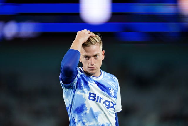 Liam Delap runs his hand through his hair in a warm-up for a Chelsea game