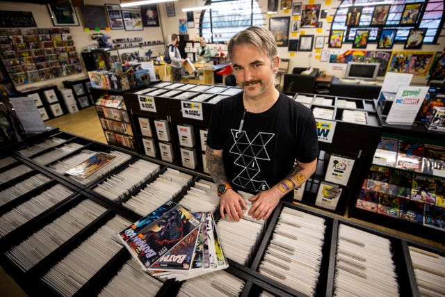 Owner Allan Taylor inside Coffee & Heroes comic book store and coffee shop in Belfast’s Smithfield Market (Liam McBurney/PA)