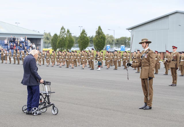 Captain Sir Tom Moore inspects the junior soldiers at their passing-out parade
