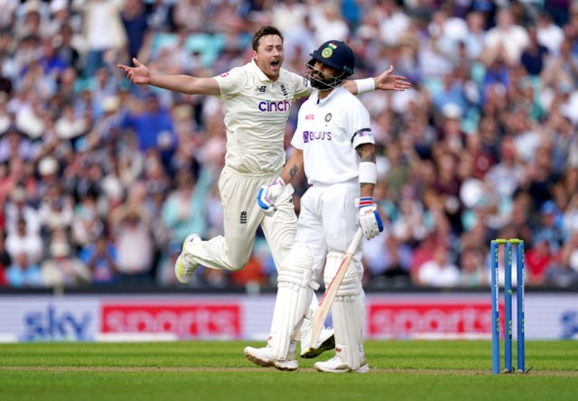 Ollie Robinson, left, celebrates the wicket of Virat Kohli