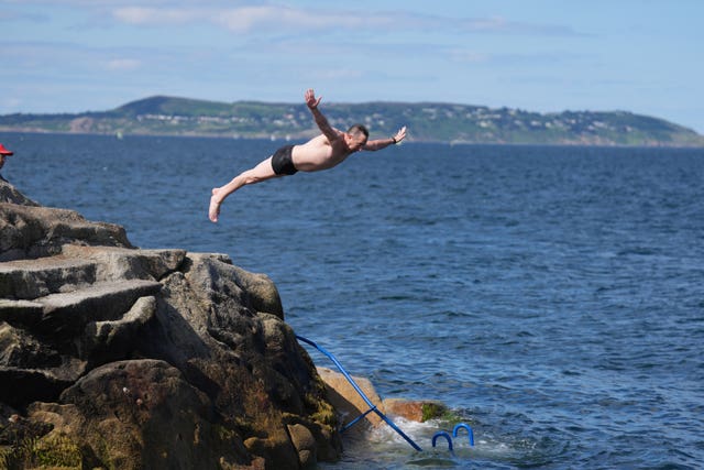 People jump into the water at the Forty Foot