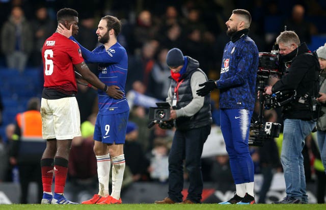 Manchester United's Paul Pogba and Chelsea's Gonzalo Higuain embrace