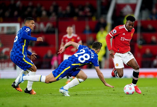 Manchester United's Anthony Elanga battles for the ball with Chelsea’s Thiago Silva and Cesar Azpilicueta