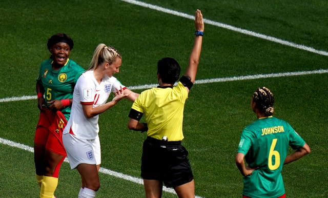 Toni Duggan, second left, shows match referee Qin Liang after being spat on by Cameroon's Augustine Ejangue, left