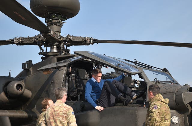Defence Secretary Gavin Williamson climbs out of the cockpit of an Apache helicopter at Wattisham Airfield in Suffolk