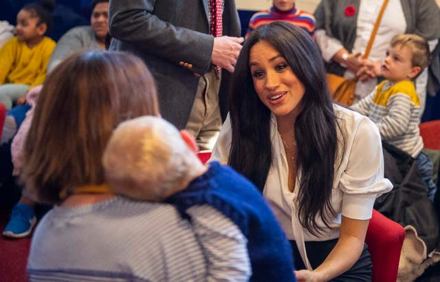 Meghan chats with a mother