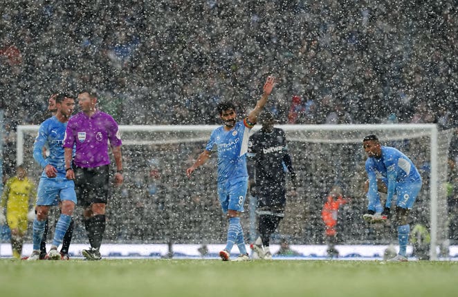 Ilkay Gundogan celebrates his opener as the snow came down