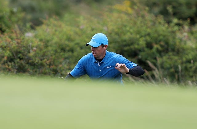 McIlroy looks for his ball on the 5th green