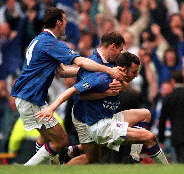 Chesterfield's Jamie Hewitt is swamped by overjoyed team-mates after his extra-time equalizer against Middlesbrough