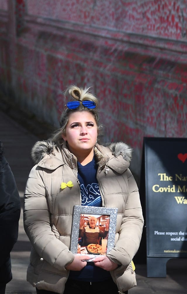 Abbie Weetman holds a photograph of her grandfather, Clement David Abbott, who died from coronavirus