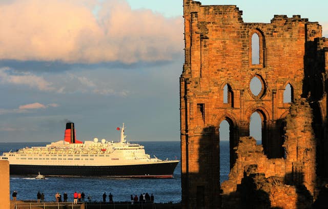 The QE2 successfully enters the mouth of the Tyne at Tynemouth in 2007 (Owen Humphreys/PA)