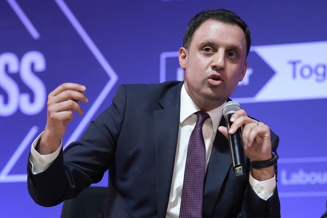 Anas Sarwar gesturing while speaking into a mic