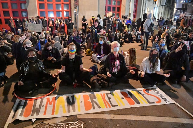 After marching through the city centre people staged a sit in outside Bridewell police station (Ben Birchall/PA).