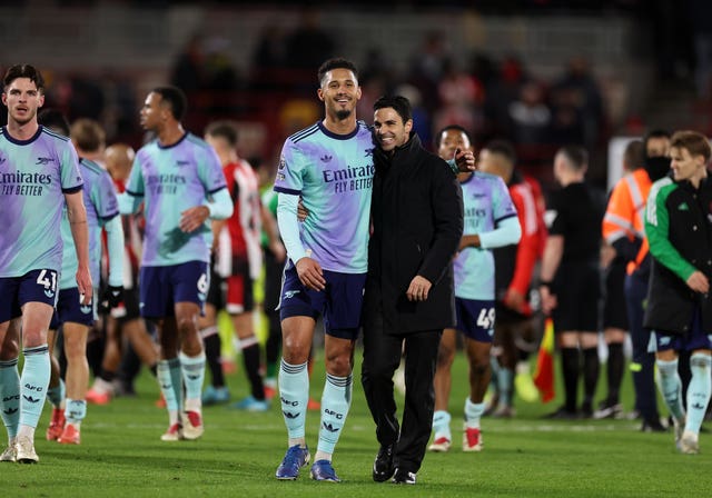 Arteta (right) hugs Saliba