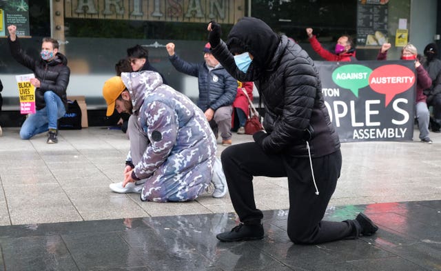 People take part in a Take The Knee event outside the Guildhall, Southampton