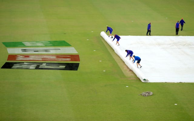 Match officials and ground staff inspect the field at Hampshire Bowl, Southampton, on Monday