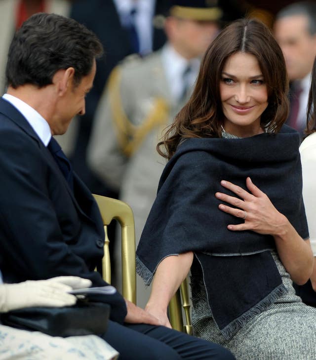 Carla Bruni-Sarkozy (right), looks to her husband President Nicolas Sarkozy, during a parade at The Royal Hospital Chelsea in London