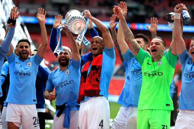 Sergio Aguero (second left) celebrates with the FA Cup trophy in 2019