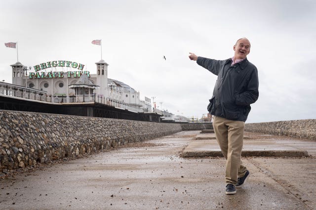 Sir Ed Davey pointing towards Brighton Palace Pier