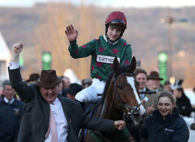 Brian Hughes celebrates on Mister Whitaker after victory at Cheltenham