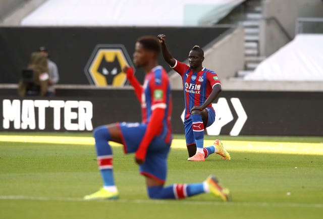 Wilfried Zaha takes a knee for Black Lives Matter prior to a Premier League game