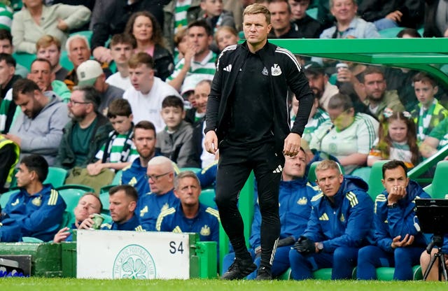 Eddie Howe stands in front of the Celtic Park dugouts