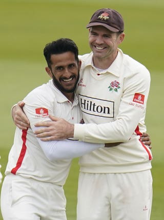 James Anderson (right) congratulates his team-mate Hasan Ali after he takes the wicket of Hampshire’s Keith Barker