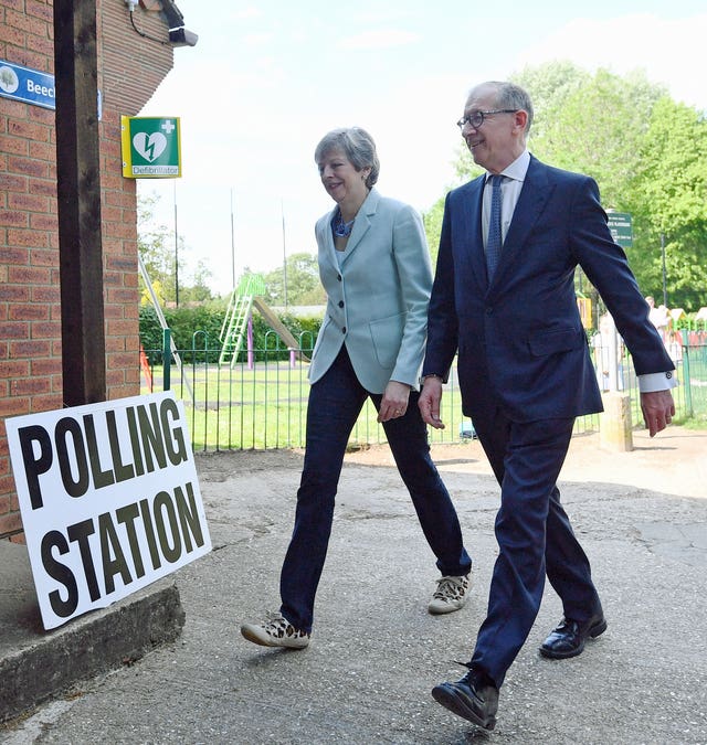Prime Minister Theresa May and her husband Philip arrive to cast their votes at a polling station near her Maidenhead constituency