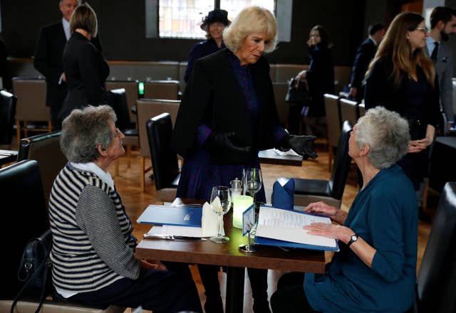 The Duchess of Cornwall (centre) speaks to diners at The Clink restaurant (Phil Noble/PA)