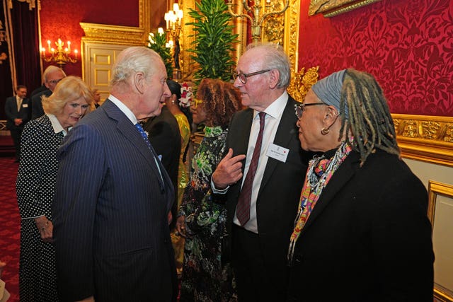 Charles speaking to actor Peter Davison during the reception